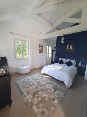 a bedroom with a bed and a blue wall at Lou Pantai, Bed and Breakfast, Delux Bedroom with AC in Aix-en-Provence