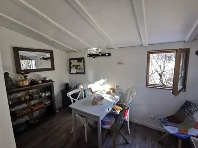 a room with a table and chairs and a window at Entre Ventoux et Luberon, appartement dans maison. in Malemort-du-Comtat