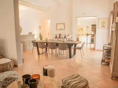 a kitchen with white walls and a table with a sculpture at La Roque in La Roque-sur-Pernes