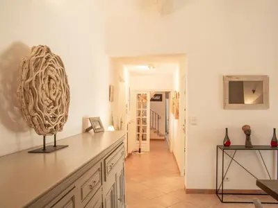 a kitchen with white cabinets and a sink at La Roque in La Roque-sur-Pernes