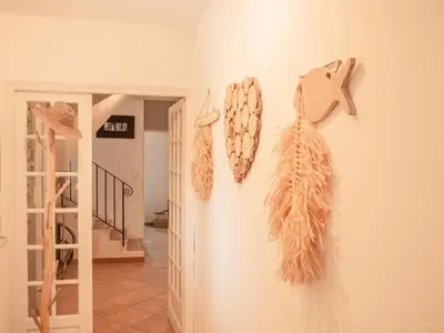 a bedroom with a large white bed with two lamps at La Roque in La Roque-sur-Pernes