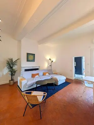 a large living room with a bed and a couch at UNE TERRASSE SUR LES TOITS in Aix-en-Provence