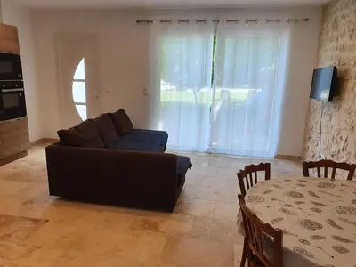 a living room with a couch and a table at Petite maison en campagne in Pernes-les-Fontaines