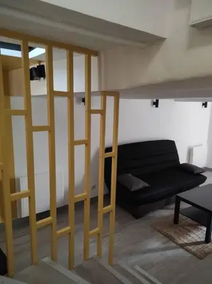 a living room with a loft bed and a couch at Maison de village avec exterieur in Lambesc