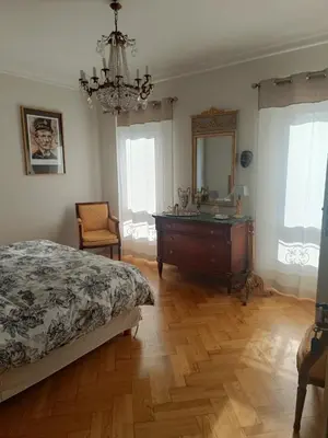a bedroom with a bed and a dresser and a mirror at Le mas de l'Auzon in Carpentras