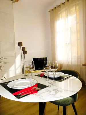 a white table with wine glasses on top of it at AUGUSTINS FOUNTAIN Studio Cosy AIX Centre Historique à 3 minutes de COURS MIRABEAU -WIFI-SMART TV-RUE CALME in Aix-en-Provence