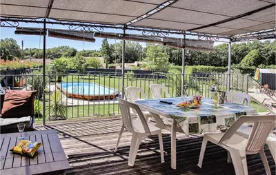 a patio with a table and chairs and a pool at Gorgeous Home In Aubignan in Aubignan