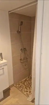 a shower with a shower head in a bathroom at Cosy House in Carpentras