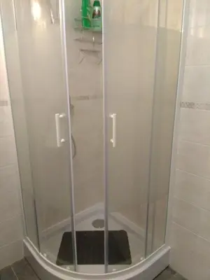 a shower with a glass door in a bathroom at Les Studios proche du Mont Ventoux in Mazan