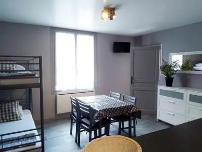 a room with a table and chairs and a bed at Les Studios proche du Mont Ventoux in Mazan