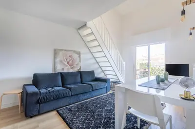 a living room with a blue couch and a table at Charmant T3 proche centre ville avec parking in Aix-en-Provence
