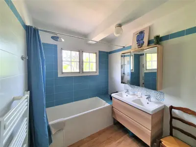 a blue bathroom with a tub and a sink at Chambre d'hôte BB proche d'Aix en Provence in Éguilles