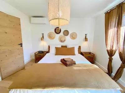 three hats are hanging on a white wall at Villa Piscine Vue exceptionnelle in Murs