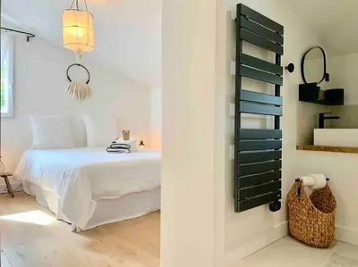 a bedroom with a bed and a table and a window at Villa Piscine Vue exceptionnelle in Murs