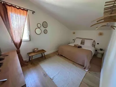 a bedroom with a bed and a flat screen tv at Villa Piscine Vue exceptionnelle in Murs