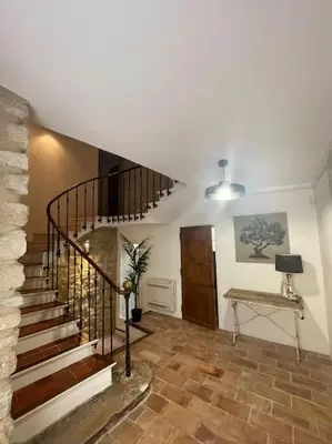 a living room with a staircase and a stair case at Maison de village in Pernes-les-Fontaines