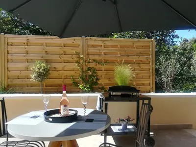 a table with a bottle of wine and two glasses at Le Mazet d'Olivia, escapade romantique en Provence in Châteauneuf-de-Gadagne