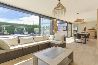 a living room with a couch and a table at Le Mas des Oliviers in Châteaurenard