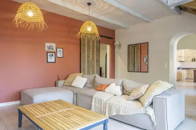 a living room with a couch and a table at Le Mas des Oliviers in Châteaurenard