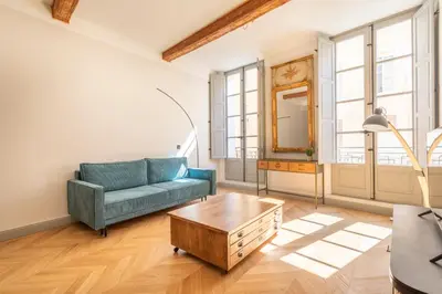 a living room with a blue couch and a coffee table at Magnifique appartement centre historique in Aix-en-Provence