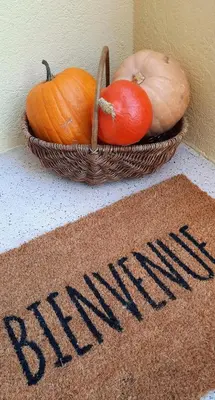 a basket of pumpkins sitting next to a welcome sign at Villa ELISABETH in Aix-en-Provence