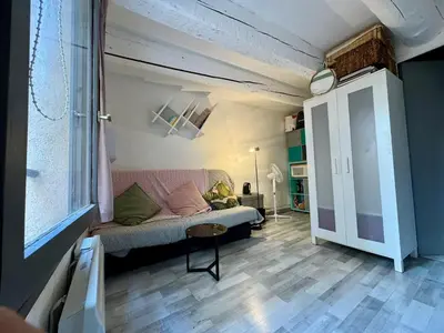 a living room with a couch and a table at Studio cosy hypercentre Aix in Aix-en-Provence