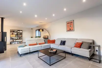 a living room with a couch and a table at Villa Feijoa en Provence in Velleron