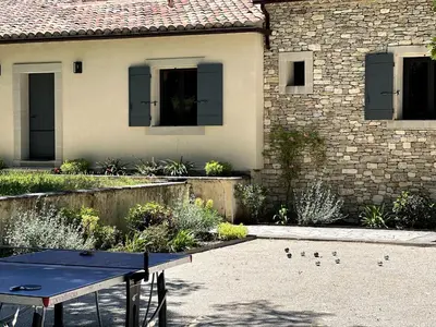 a ping pong table in front of a house at Villa Feijoa en Provence in Velleron