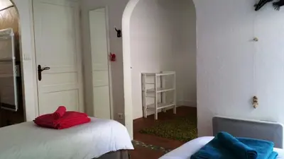 a room with a bed with a red pillow on it at Charm in Provence in Saumane-de-Vaucluse
