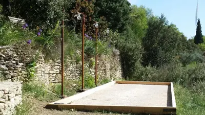 a large mattress in a field next to a stone wall at Charm in Provence in Saumane-de-Vaucluse