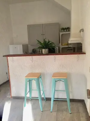 two blue and brown stools sitting at a counter at Appartement Emil centre ville in Carpentras