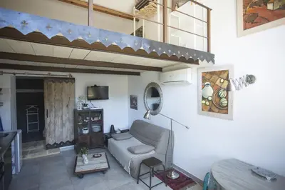 a living room with a couch and a table at Appartement dans Mas Provencal in Grans