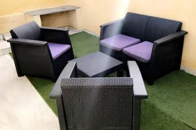 two chairs and a table in a room with grass at Studios moderne et spacieux in Morières-lès-Avignon