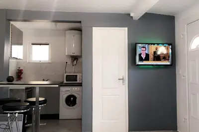 a kitchen with a tv hanging on a wall at Studios moderne et spacieux in Morières-lès-Avignon