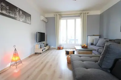 a living room with a couch and a television at Le Blondel in Aix-en-Provence