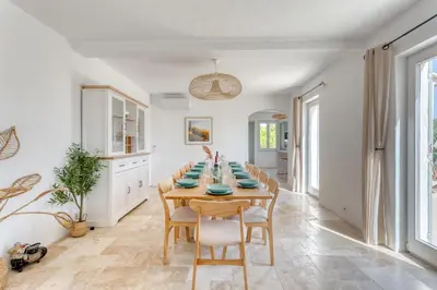 a kitchen and dining room with a table and chairs at Le mas sous les étoiles in Joucas