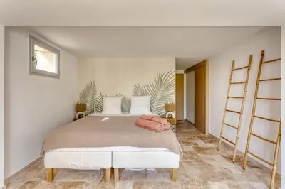 a bedroom with a large bed in a room at Le mas sous les étoiles in Joucas