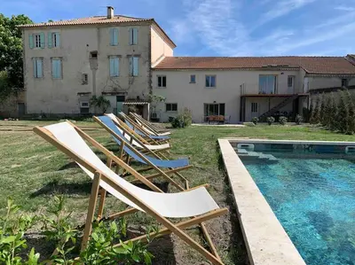 a group of lawn chairs sitting in front of a house at L'appart des Anges in Althen-des-Paluds