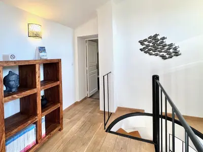 a staircase in a room with wooden shelves at provence living in Roussillon