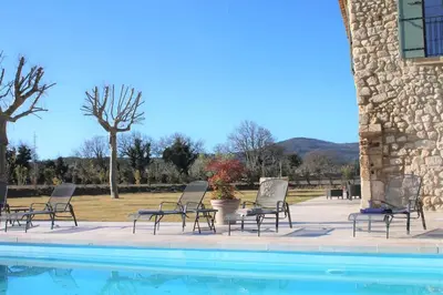 a group of chairs sitting next to a swimming pool at Mas en campagne in Mallemort