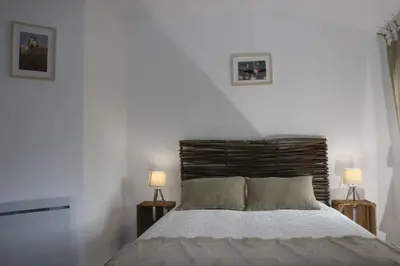 a bedroom with a large bed with two lamps at Mas en campagne in Mallemort