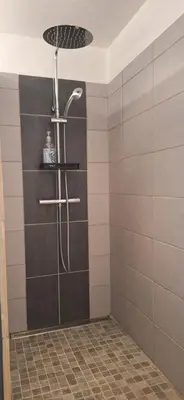 a shower with a shower head in a bathroom at Loft en duplex au Mas de la Restanque in Monteux