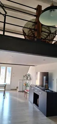 a large room with a kitchen with a table and chairs at Loft en duplex au Mas de la Restanque in Monteux