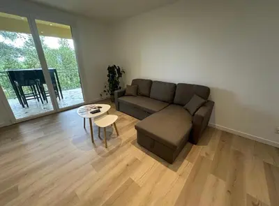 a living room with a couch and a table at L’Amistouso in Vedène