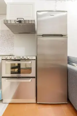 a stainless steel refrigerator and stove in a kitchen at Duplex en plein centre historique Aix en provence in Aix-en-Provence