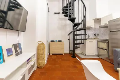 a kitchen with a spiral staircase in a room at Duplex en plein centre historique Aix en provence in Aix-en-Provence