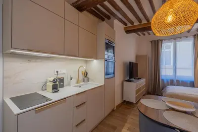 a kitchen with a sink and a table in a room at Appartement de charme in Aix-en-Provence