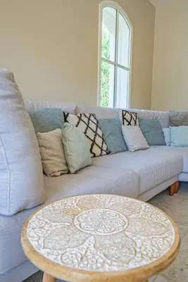 a living room with a couch and a coffee table at Villa des Fontaines luxury family home with pool in Pernes-les-Fontaines