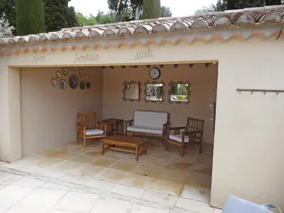 a patio with two chairs and a table and a table and chairs at Villa Le Bouloulou by Interhome in Velleron