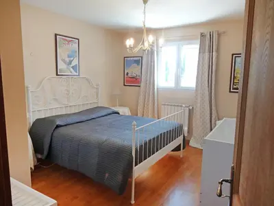 a bedroom with a bed and a window and a tub at Villa Le Bouloulou by Interhome in Velleron